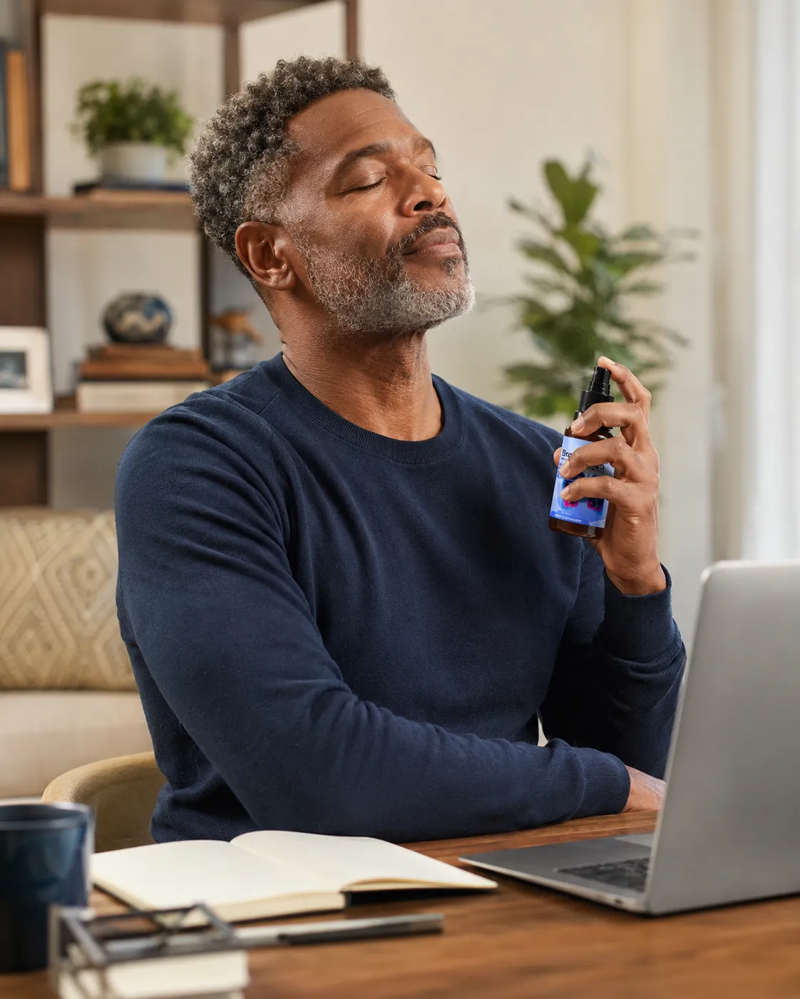 Man using Breathizen spray at his desk during a work-from-home routine